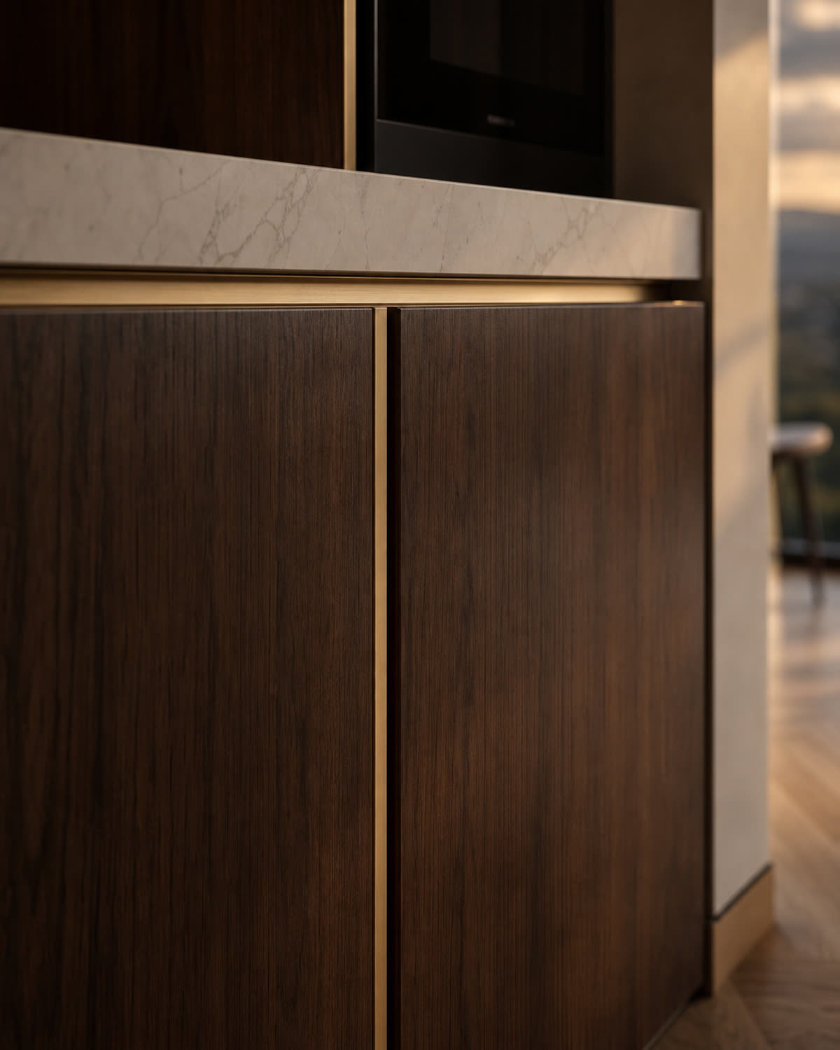Handleless walnut kitchen cabinetry, brass edge
